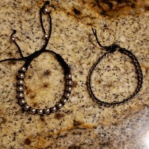 2 black and silver bracelets